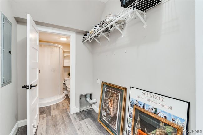 Spacious closet with arched walkways and wood finished floors | Image 26