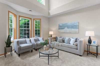 This charming, colonial-style, two-story townhouse offers a perfect blend of modern updates and classic design. Recently refreshed with new paint and carpet the home exudes a welcoming and pristine ambiance. | Image 1