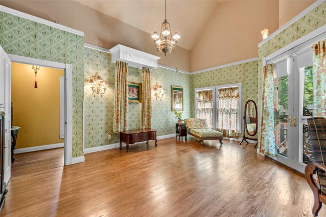 Living area featuring a notable chandelier, high vaulted ceiling, and wood finished floors | Image 28
