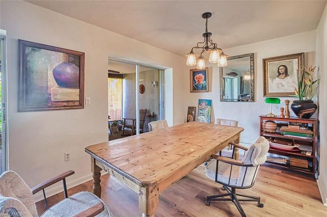 Dining area featuring light wood finished floors and a chandelier | Image 13