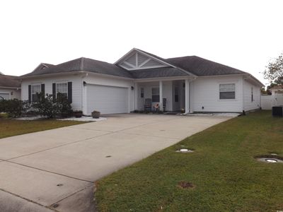 View of front of home featuring cooling unit, a front lawn, and a garage | Image 2