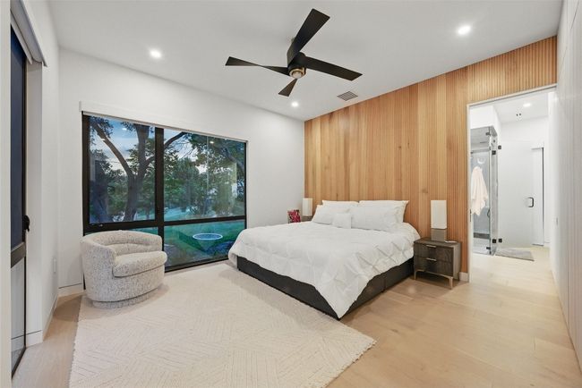 Bedroom featuring wood walls, recessed lighting, wood finished floors, and a ceiling fan | Image 15
