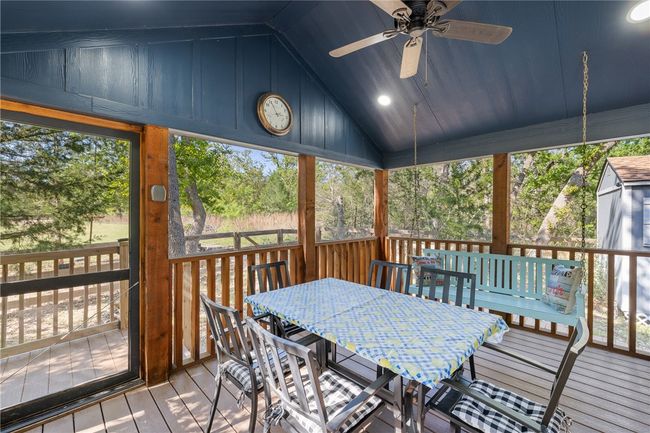 Sunroom with outdoor dining area, a ceiling fan, and plenty of natural light | Image 5