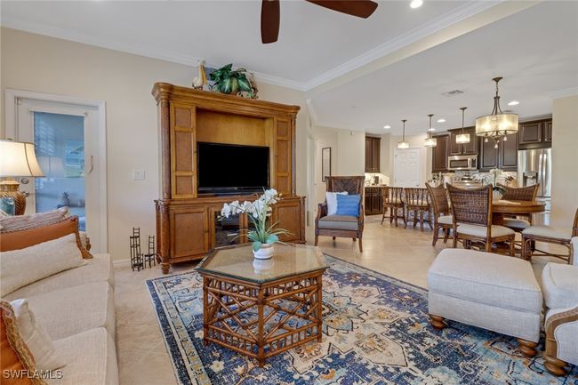 Living area featuring a ceiling fan, recessed lighting, ornamental molding, and light tile patterned floors | Image 11