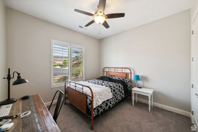 Bedroom with visible vents, baseboards, and ceiling fan | Image 24