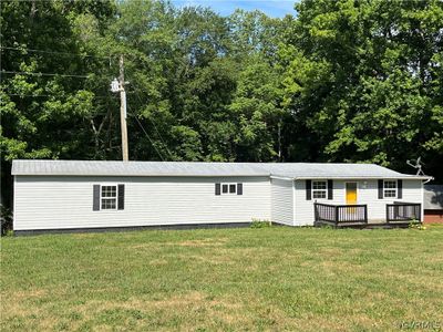 View of front of house with a wooden deck and a front lawn | Image 3