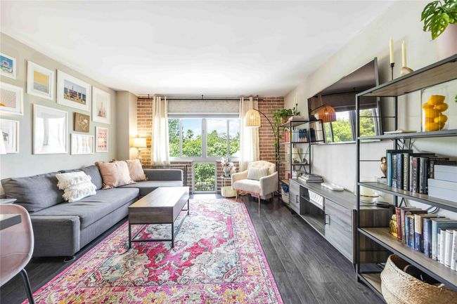 A charming brick accent wall adds a distinctive touch of character and style to the space. | Image 8