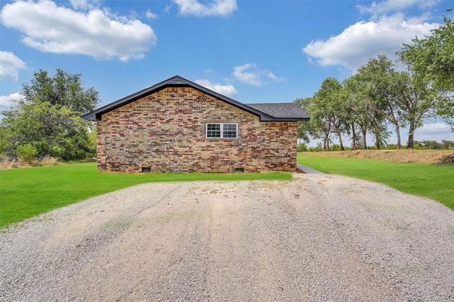 View of side of home featuring a yard | Image 44