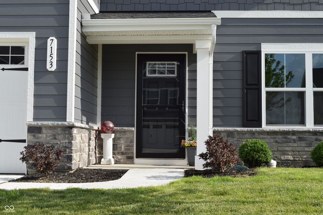 inviting and covered front porch ~ upgraded with storm door | Image 4