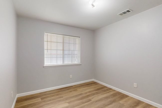 Unfurnished room featuring visible vents, baseboards, and light wood-style floors | Image 13
