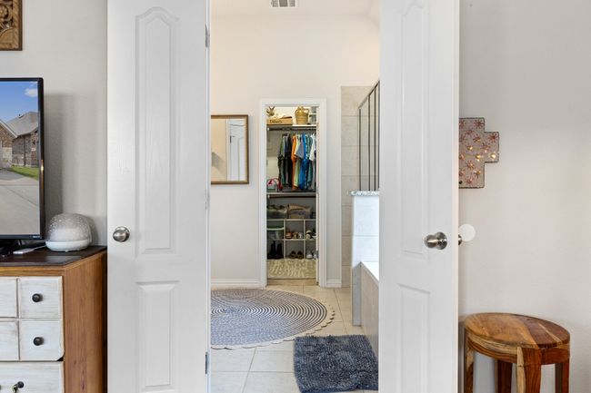 Full bath with a tub to relax in, visible vents, tile patterned flooring, and a shower | Image 17