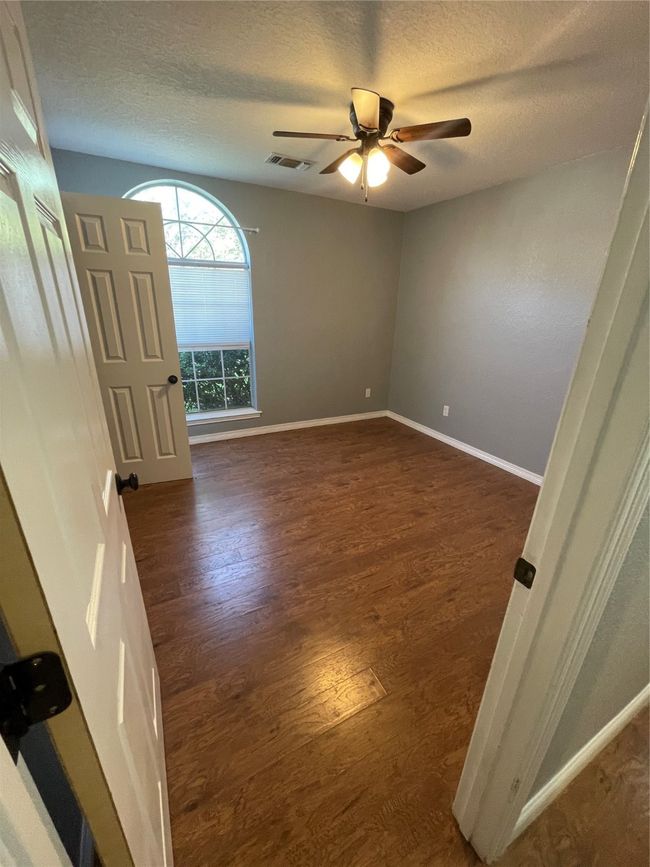 Unfurnished room with a textured ceiling, ceiling fan, and dark hardwood / wood-style floors | Image 5