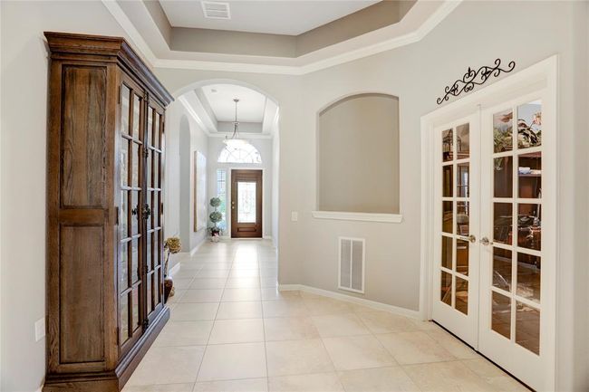 The foyer opens to a spacious, well-lit hallway, with French doors leading to the dedicated study. | Image 5