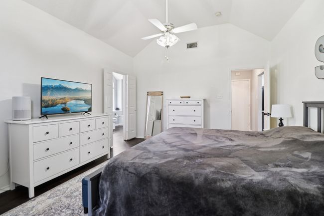 Bedroom with dark wood-style flooring, high vaulted ceiling, and ceiling fan | Image 20