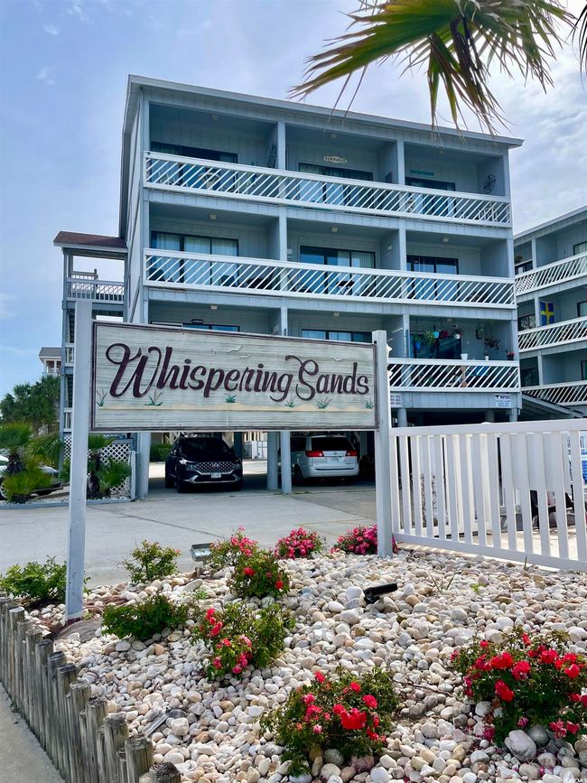View of building exterior featuring covered parking | Image 32