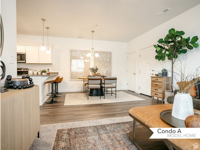 Living area with a chandelier, visible vents, baseboards, and wood finished floors | Image 8