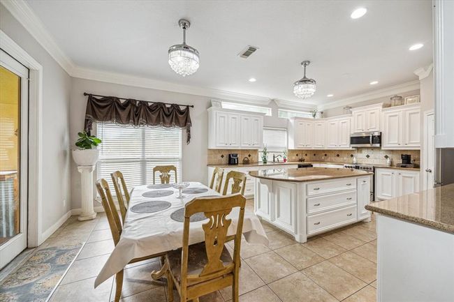 Light and bright breakfast area overlooking covered patio. Lots of accent windows throughout the home allowing tons of natural light to flow in. | Image 13