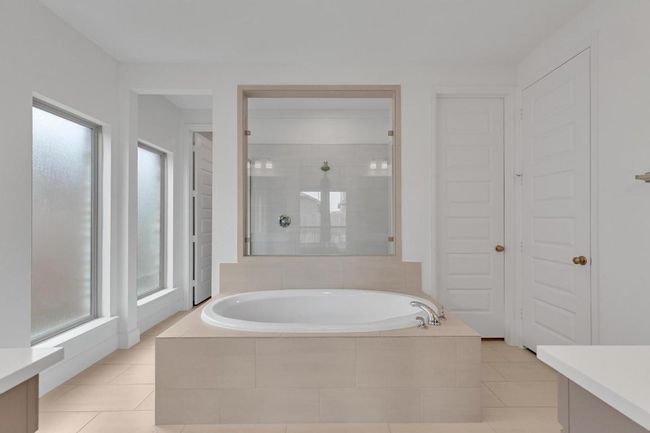 Bathroom featuring vanity, a bath, plenty of natural light, and tile patterned flooring | Image 31