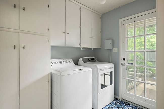 Laundry room just off of the garage, with tons of built in storage | Image 30