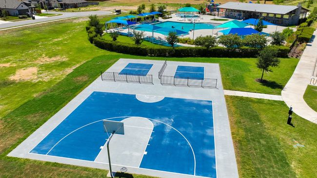 View of sport court featuring fence, a yard, and a tennis court | Image 7