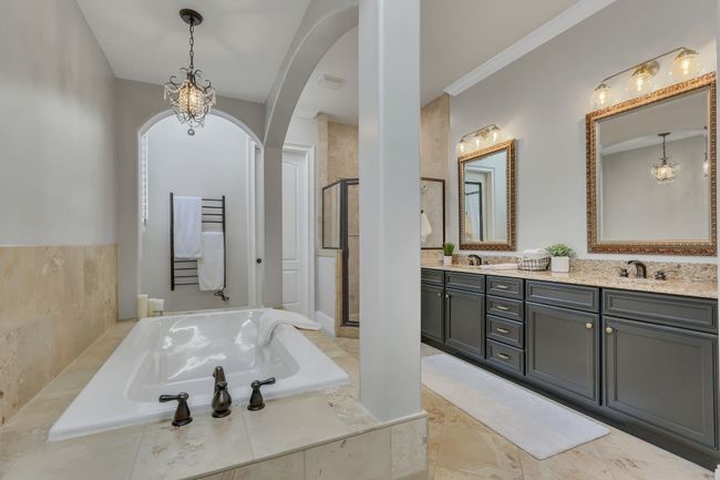 The bath has the repeating graceful arches found elsewhere in this custom-built home. The attention to detail is stunning! | Image 32