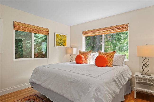 Bedroom with wood finished floors and baseboards | Image 15