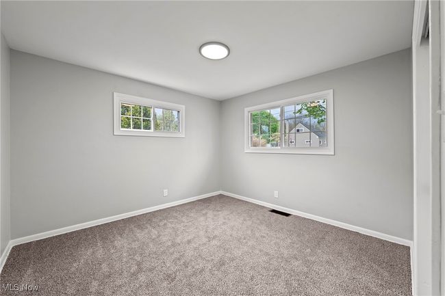 Unfurnished room with visible vents, carpet flooring, and baseboards | Image 21