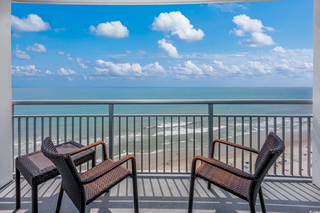 Balcony featuring a view of the beach and a water view | Image 18