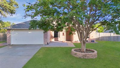 View of front of home with a garage and front yard | Image 1