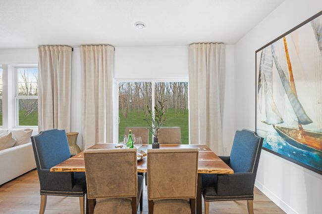 Photo is of the actual model. Soaked in natural sunlight, the homes eat-in dining room has ample space for a dining table located in the heart of the home. | Image 5