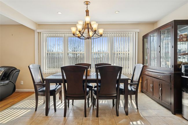 Dining space with a notable chandelier, recessed lighting, baseboards, and light tile patterned floors | Image 18