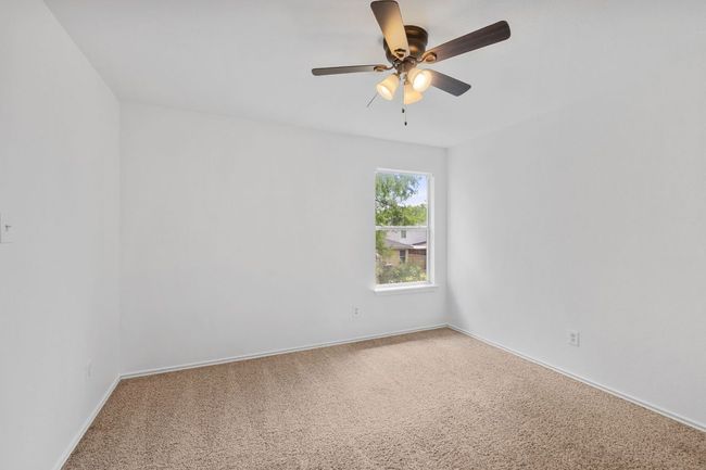 Spare room with carpet floors, ceiling fan, and baseboards | Image 25