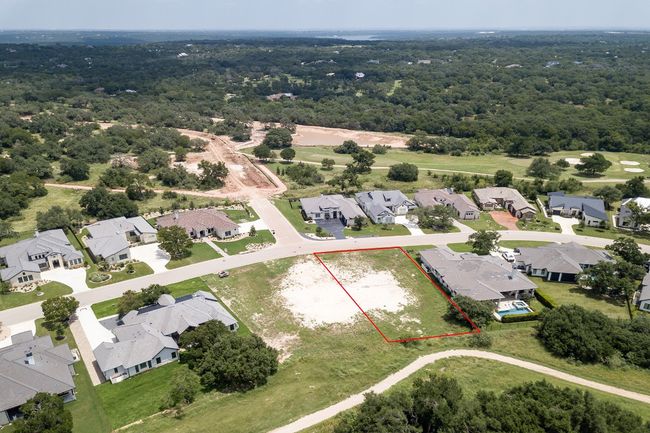 Aerial perspective of suburban area with property boundaries highlighted and a forest | Image 7