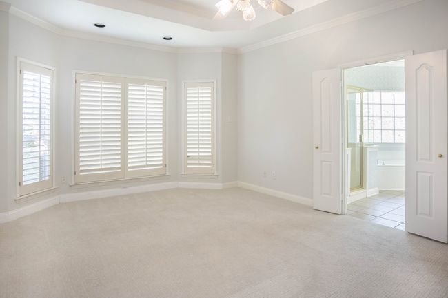 Primary Bedroom wit light colored carpet, a ceiling fan, and ornamental molding | Image 12