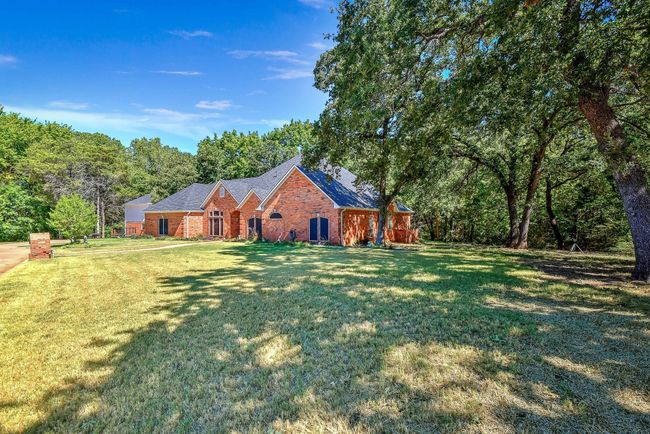 View of front of home with brick siding and a front yard | Image 5