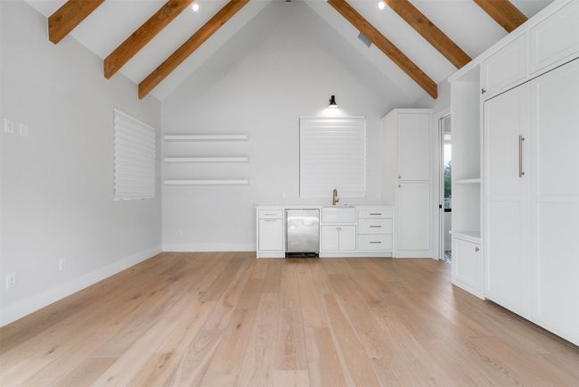 The casita is a perfect retreat, featuring a large living/bedroom area with vaulted wood-beamed ceilings that create a sense of spaciousness, while the kitchenette provides the convenience of easy meal prep | Image 36