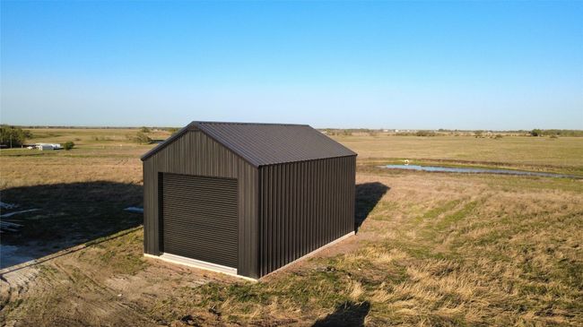 View of outdoor structure featuring a water view, an outdoor structure, and a rural view | Image 16