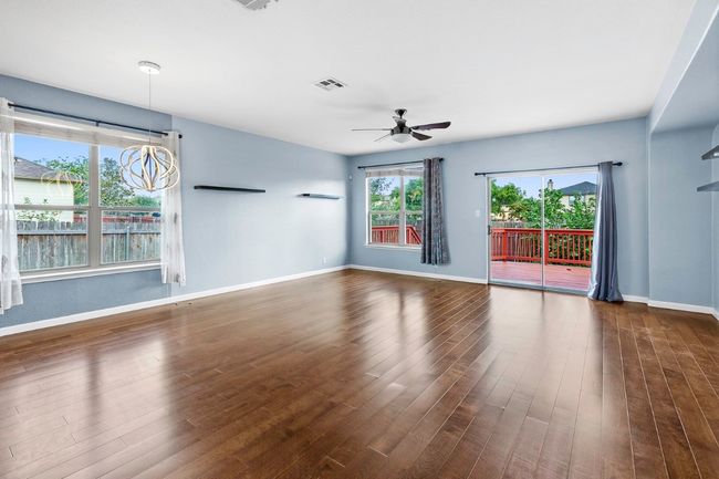 Unfurnished living room featuring dark wood finished floors and a ceiling fan | Image 8