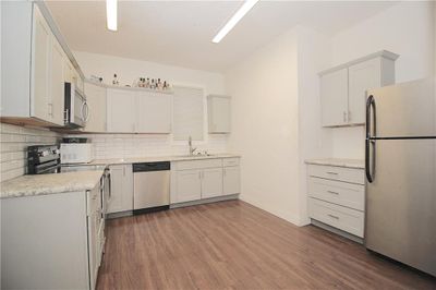 Kitchen featuring tasteful backsplash and stainless steel appliances | Image 3