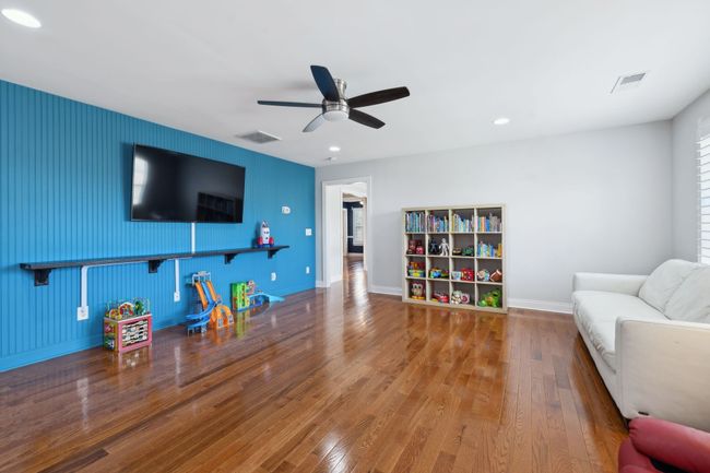 Bonus room features built-in shelving, play area, and vibrant accent wall. | Image 33