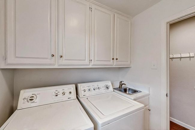 Washroom with washing machine and clothes dryer and cabinet space | Image 35