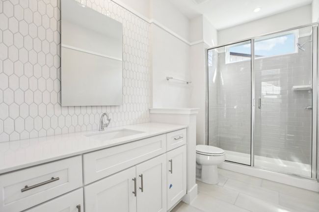 Full bathroom featuring toilet, a stall shower, vanity, and tile patterned flooring | Image 30