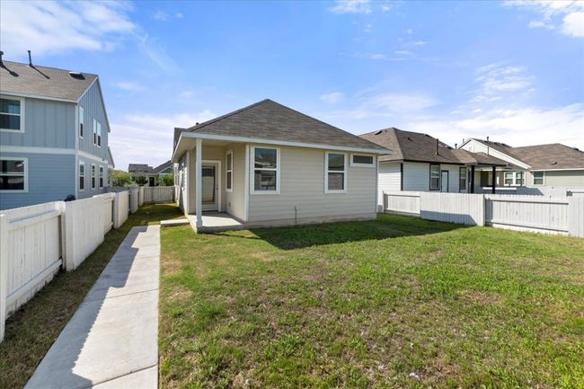 View of front facade with a residential view, a shingled roof, a fenced backyard, and a front lawn | Image 28