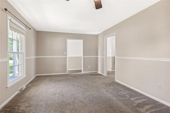 Carpeted spare room featuring ceiling fan, healthy amount of natural light, and baseboards | Image 32