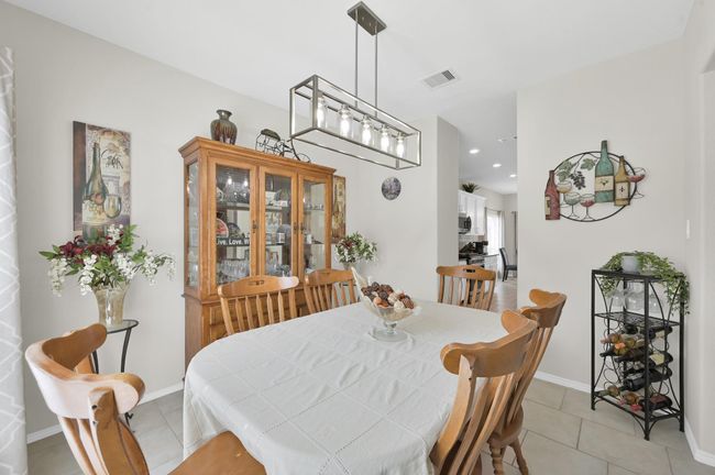 The dining room sits just off the foyer, ideal for welcoming your dinner guests. | Image 6