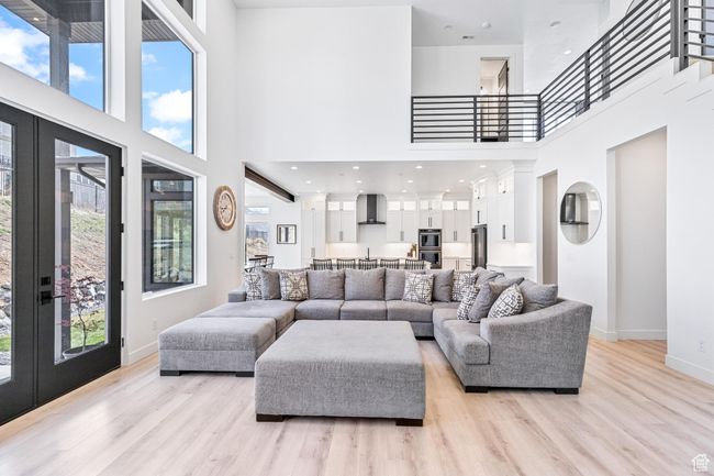 Living area featuring french doors, a high ceiling, and a healthy amount of sunlight | Image 15