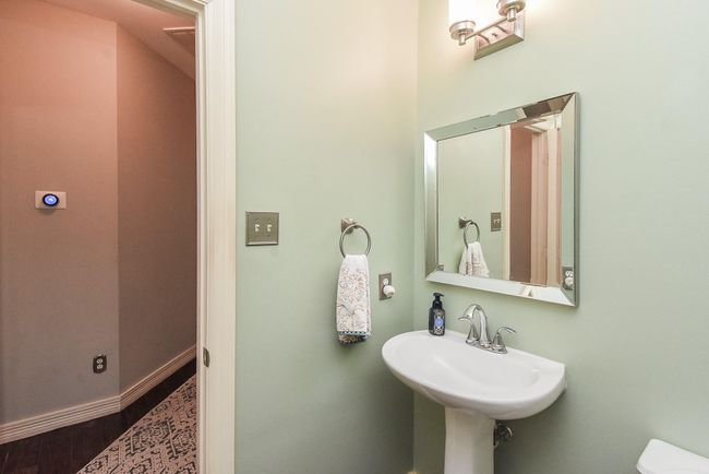 Also, your living area conveniently has a half bathroom with charming pedestal sink for your guests to use and not have to walk up and down the stairs. | Image 13