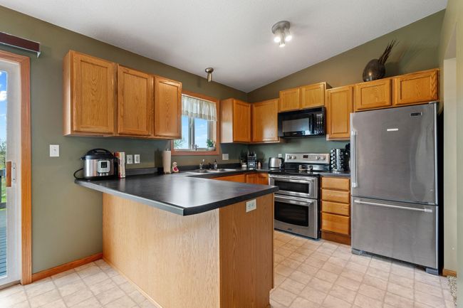 908 24th Ave NW - stainless appliances and peninsula for extra storage; stools could be added for extra seating | Image 7