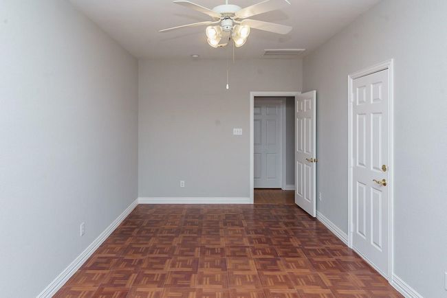 Spare room with ceiling fan, visible vents, and baseboards | Image 15