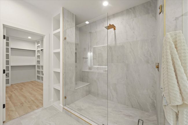 Full bathroom with a walk in closet, a marble finish shower, and recessed lighting | Image 16